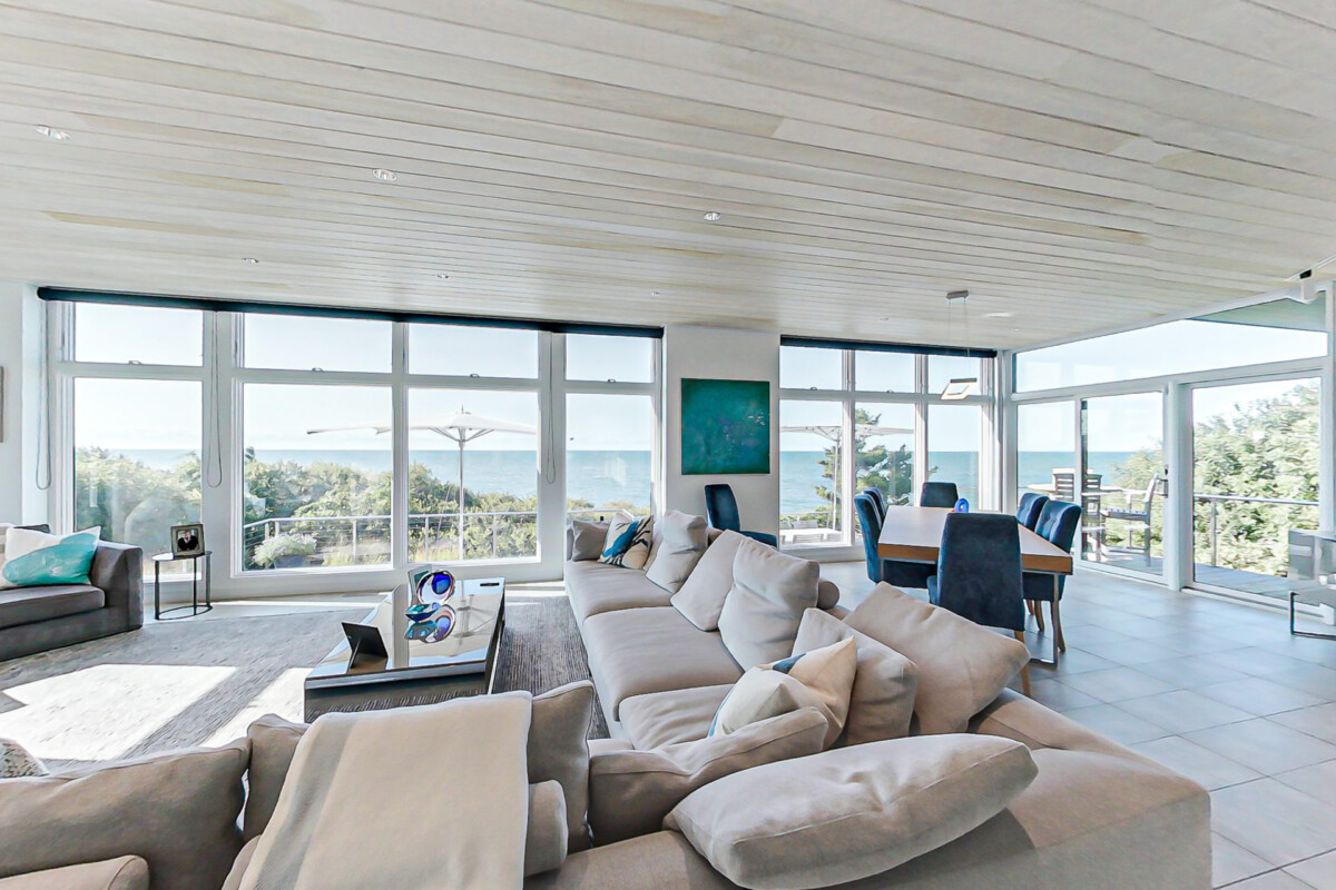 Living Room and Dining Room overlooking the ocean in a 2-story contemporary style home in Brewster, MA.